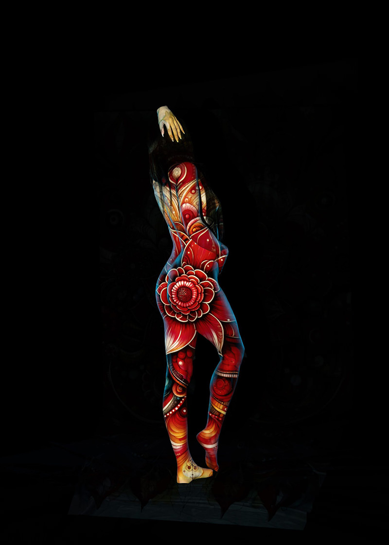 Person posing on tiptoe, covered in detailed red and orange floral body paint with intricate designs, set against a black background