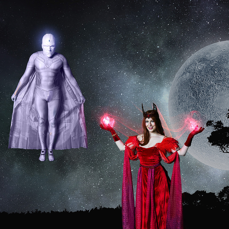 A woman in a red costume with glowing red energy in her hands stands beside a levitating figure in a glowing purple suit with a cape, set against a starry night sky with a large moon and silhouetted trees.
